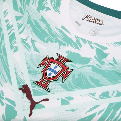 A close-up of the chest area of a Portugal national football team jersey, featuring a white and mint green abstract marbled pattern. The team crest is centered, with a dark maroon textured Puma logo on the lower left and stylized "PORTUGAL" text inside th