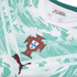 A close-up of the chest area of a Portugal national football team jersey, featuring a white and mint green abstract marbled pattern. The team crest is centered, with a dark maroon textured Puma logo on the lower left and stylized "PORTUGAL" text inside th