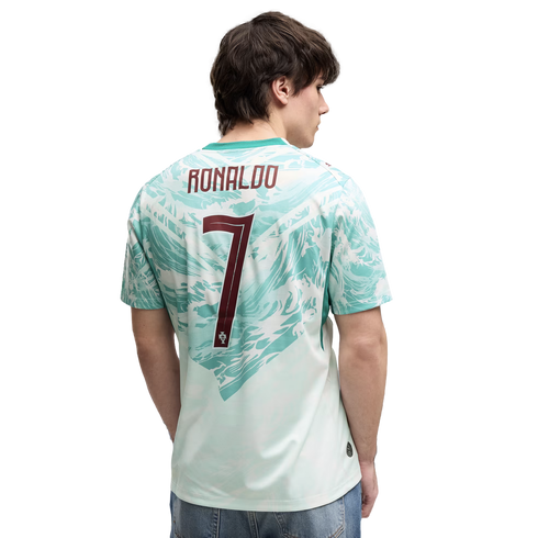 Back view of a man wearing a mint green and white patterned Portugal soccer jersey with "RONALDO" and the number "7" in maroon on the back.