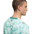 A back and side profile of a man with short hair wearing a white and teal abstract-patterned t-shirt. The shirt features a solid teal collar, the word "PORTUGAL" on the upper back, and a small Puma logo on the shoulder.