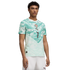 A young man models a white and light green abstract-patterned soccer jersey with a central crest and the number 7, paired with white shorts, against a black background.