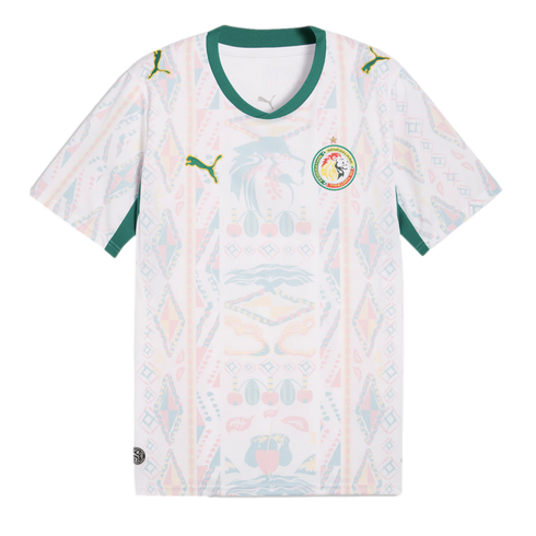 A white Senegal national football team away jersey featuring a green V-neck collar and sleeve trim. The shirt has a faint, multi-colored geometric and lion-head pattern across the front, with the Puma logo on the right chest and the Senegalese football fe