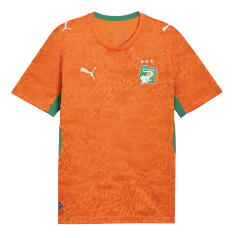 An orange Puma soccer jersey for the Côte d'Ivoire national team. It features an all-over tonal leopard print pattern, a green collar, and green side panels. The team's elephant crest with three stars is on the left chest, and white Puma logos are on the