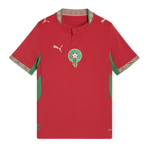 A red Morocco national football team home jersey by Puma, featuring the national team crest in the center, golden Puma logos on the right chest and shoulders, and green accents on the sides and sleeves. Intricate patterned trim adorns the collar and sleev