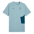 A light blue, short-sleeved Puma sports t-shirt featuring the Portugal national team crest on the left chest and a dark blue Puma logo on the right. It includes a dark teal side panel on the lower right with a vertical white zipper.