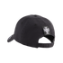 A rear-side view of a black baseball cap featuring a small white crest logo on a square patch above the adjustable strap, set against a solid black background.