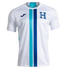 A white Honduras national team soccer jersey with turquoise and navy blue central vertical stripes, featuring the team's "H" crest and a Joma logo.