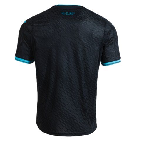 The back view of a black short-sleeved soccer jersey with a subtle, repeating geometric pattern. The sleeve cuffs and back of the collar are accented with bright turquoise trim. Centered just below the collar is small turquoise text that reads, "SELECCIÓN