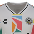 Close-up of a white Oakland Roots SC soccer jersey by Charly, featuring a large, colorful geometric pattern on the chest and the team's circular tree crest.