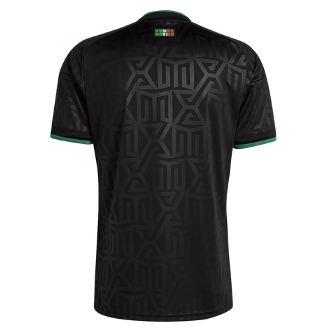 Back view of a black jersey with a tonal geometric pattern, green trim on the collar and sleeve cuffs, and a small Mexico logo on the upper back.