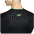 Close-up of the back of a black jersey featuring a green collar, tonal geometric patterns, and a small "SOMOS MÉXICO" patch.