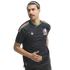 A man with a mustache in a running pose wears a black Mexico national team soccer jersey and a white headband against a white background.