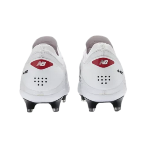 Rear view of white New Balance 442 soccer cleats featuring a red logo on the heels and black studs.