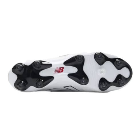 Bottom view of a white New Balance soccer cleat featuring black molded studs and a red logo on the sole.