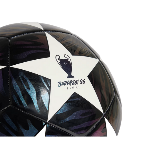Close-up of a UEFA Champions League soccer ball featuring a white star with the "BUDAPEST 26 FINAL" logo and dark, shimmering patterned panels.