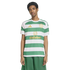 A man modeling a green and white hooped Celtic FC football jersey with gold logos and matching green shorts.