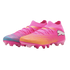 A pair of pink Puma soccer cleats with a sock-like fit. One boot features a teal-patterned toe, and the other an orange-patterned toe.