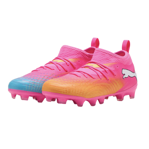 A pair of bright pink Puma soccer cleats with blue and orange gradients, pink studs, and white logos, isolated on a white background.