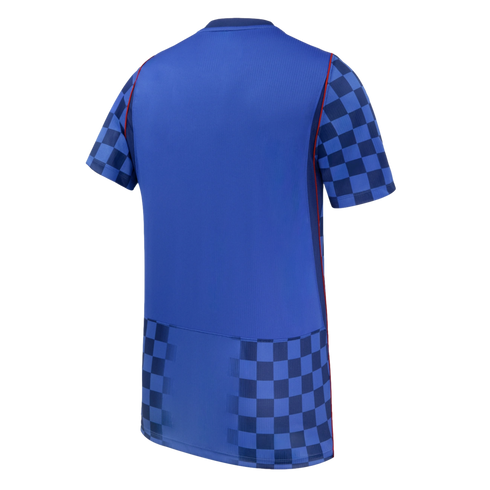 Back of a blue sports jersey featuring a navy blue checkerboard pattern on the sleeves and bottom hem, with thin red piping along the sides.