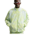 A person wearing white-framed sunglasses and a light green patterned Nike zip-up jacket with mesh panels, posing against a white background.