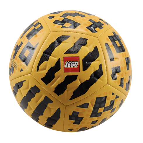 A yellow LEGO soccer ball with black abstract and pixelated patterns, featuring the red LEGO logo in the center.