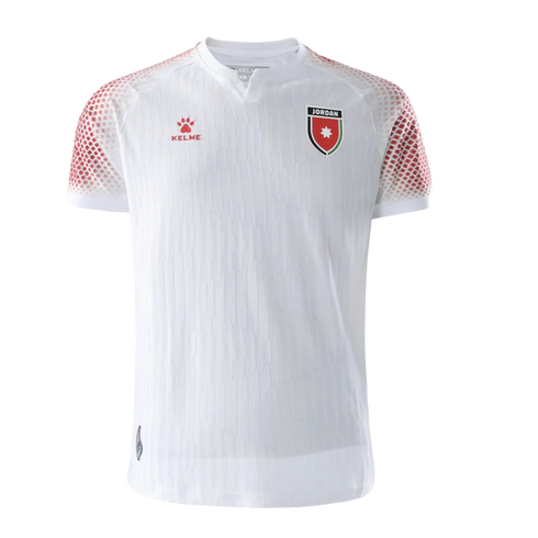 White Kelme soccer jersey for the Jordan national team featuring red patterned shoulders, the team crest, and a red brand logo on the chest.