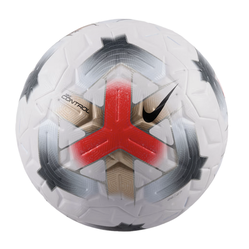 A white Nike soccer ball with a textured surface, featuring a bold red three-pronged graphic at the center, grey and gold design elements, and a black swoosh logo.