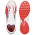 Top and bottom views of a white Puma athletic shoe featuring vibrant red graphic accents and a textured red rubber sole for traction.