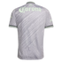 Back view of a grey soccer jersey with a wavy pattern and a large pale green "Corona" logo on the upper back. Features pale green and dark grey trim on the sleeves and collar.