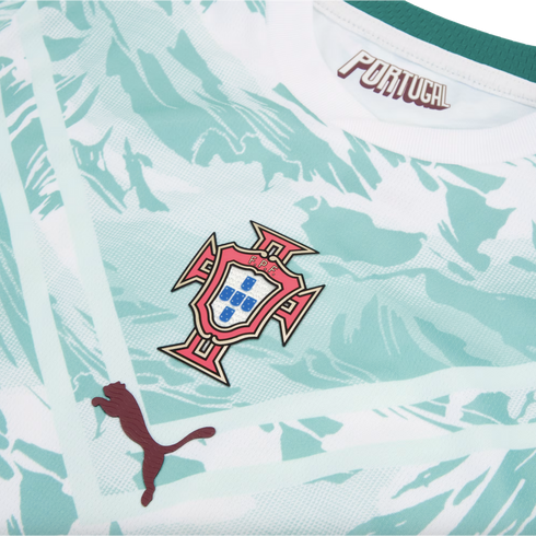 A close-up of a Portugal national football team jersey, featuring a light mint green and white marbled pattern. The central focus is the Portuguese Football Federation (FPF) crest. A dark red Puma logo is positioned to the bottom left, and the word "PORTU
