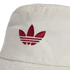 A close-up of a white bucket hat featuring a red embroidered Adidas trefoil logo on the front crown. The fabric has a subtle, repeating tonal pattern weave.
