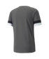 Back view of a grey short-sleeved T-shirt with black and white horizontal bands on the sleeve cuffs.