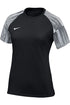 Black Nike short-sleeve athletic shirt with horizontal white and black striped raglan sleeves and a white swoosh logo on the chest.