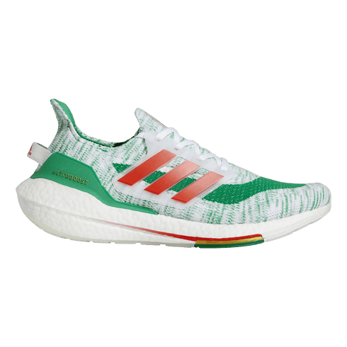A side view of an Adidas UltraBoost sneaker featuring a white and green patterned knit upper, orange side stripes, and a thick white foam midsole.