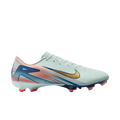 A mint green Nike soccer cleat with a gold swoosh, blue and pink side graphics, and orange studs, shown from a side profile.