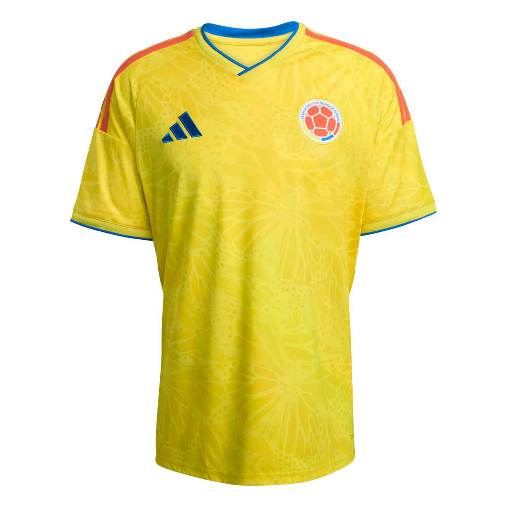 Yellow Adidas Colombia national team soccer jersey with a subtle tonal butterfly pattern, blue collar and sleeve trim, and orange shoulder stripes.