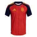 Red Spain national team soccer jersey with navy blue sleeves and collar. Features vertical stripes, a yellow Adidas logo, and the national crest.