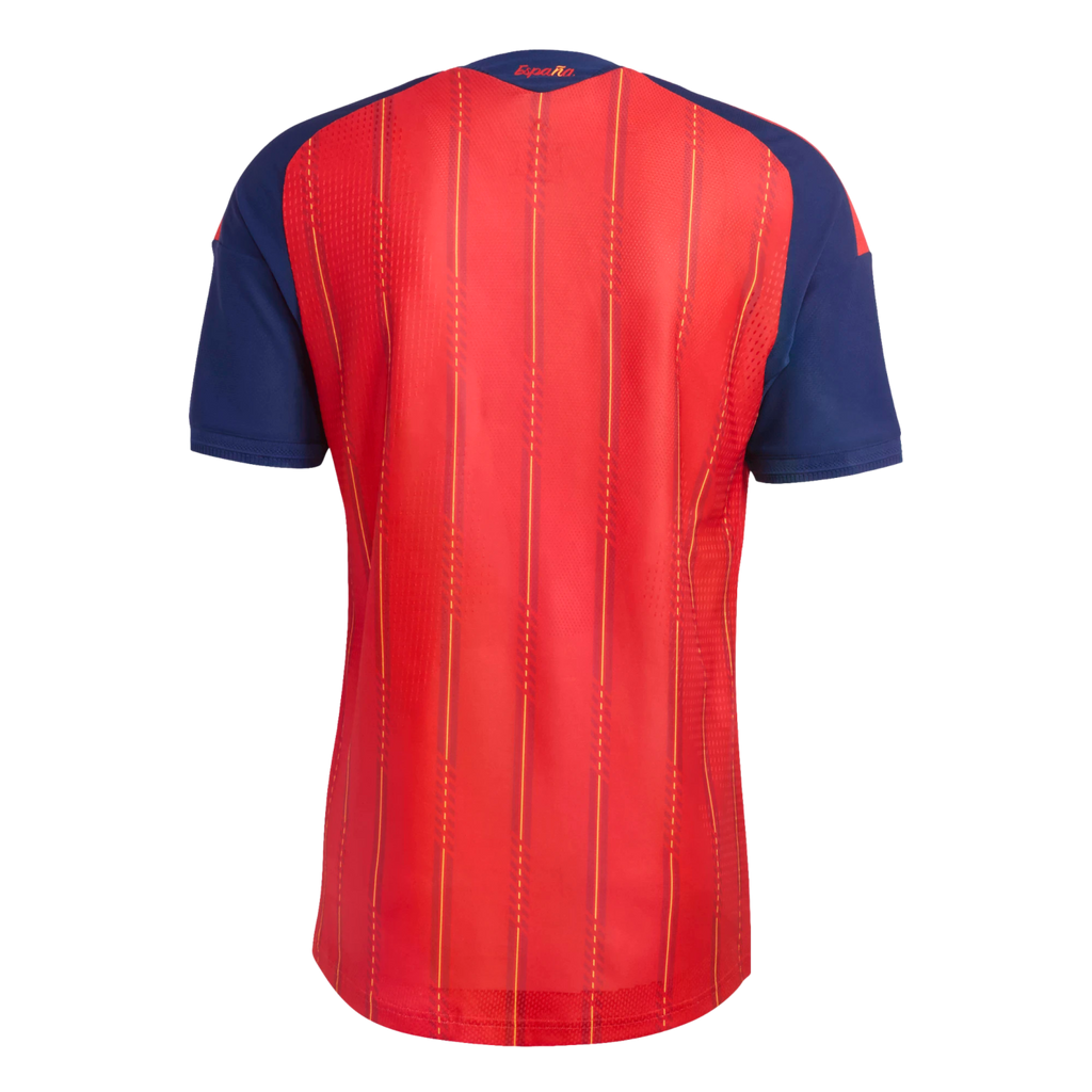 Back of a red Spain national team jersey with blue sleeves and yellow pinstripes. "España" is printed in yellow on the dark blue collar.