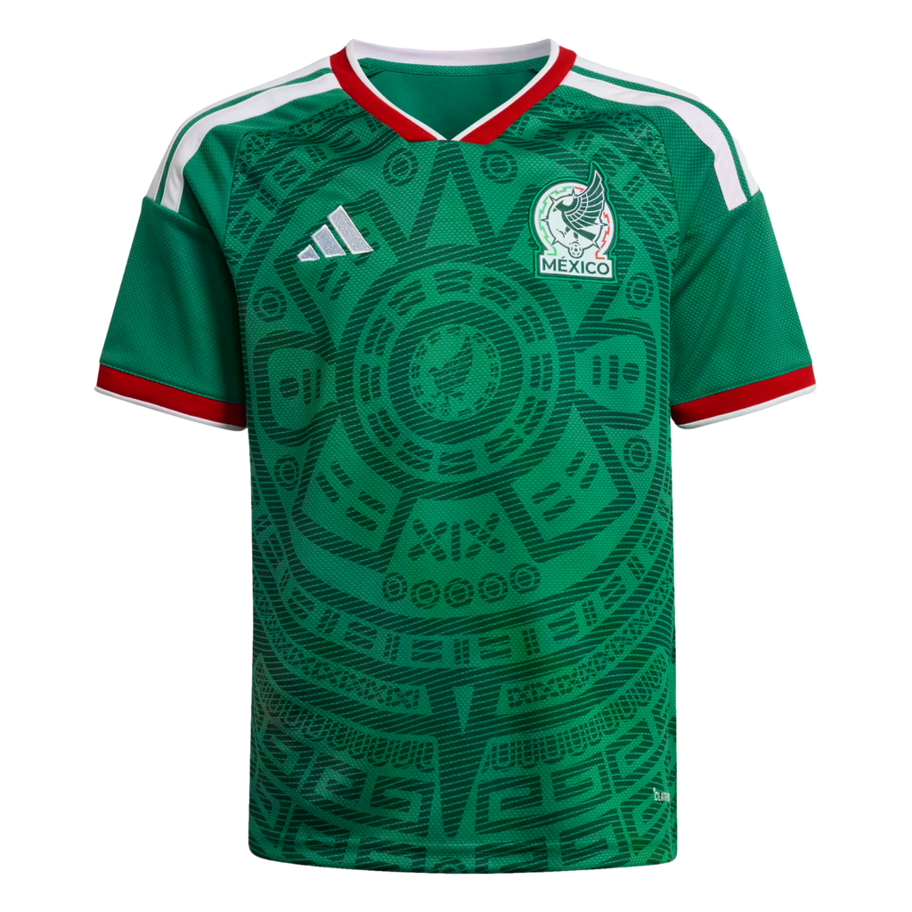 Green Mexico soccer jersey featuring an intricate Aztec graphic, white shoulder stripes, and red trim on the collar and cuffs. The team crest and Adidas logo are on the chest.