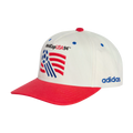 A white and red baseball cap featuring the embroidered 1994 World Cup USA logo and "adidas" branding on the side.