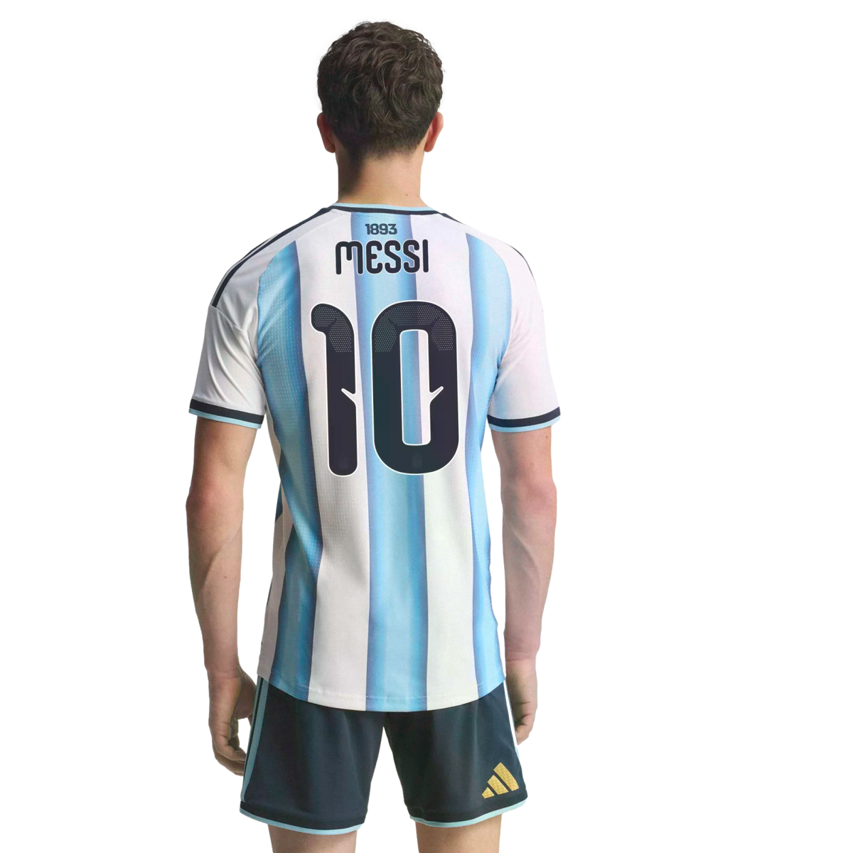 Back view of a man wearing an Argentina soccer jersey with "MESSI" and number 10, paired with dark blue shorts against a solid black background.