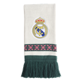 White knit scarf featuring a centered Real Madrid crest, a green horizontal band with pink geometric patterns, and long dark green fringe.